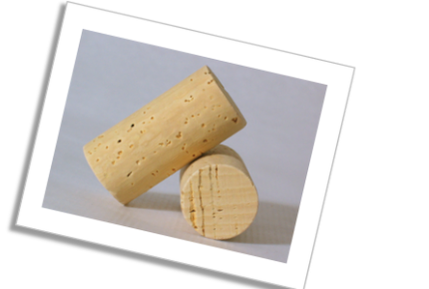 Two natural cork stoppers displayed on a white card